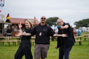 3 people posing with microphone